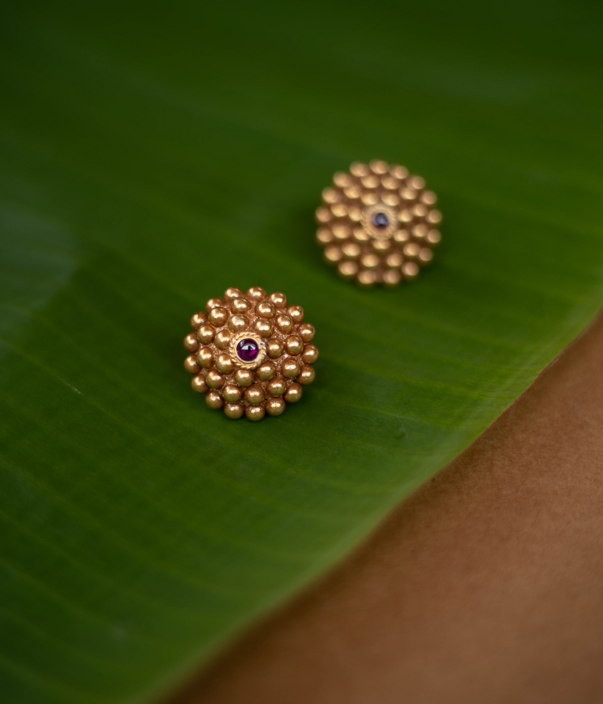 Tribal-style Rudhra earrings featuring red spinel stones, made in 92.5 sterling silver with 22ct gold plating.