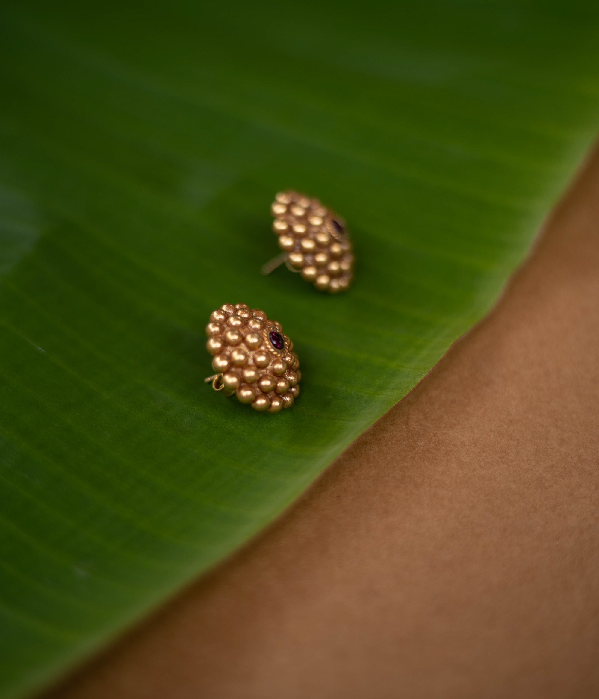 Tribal-style Rudhra earrings featuring red spinel stones, made in 92.5 sterling silver with 22ct gold plating.