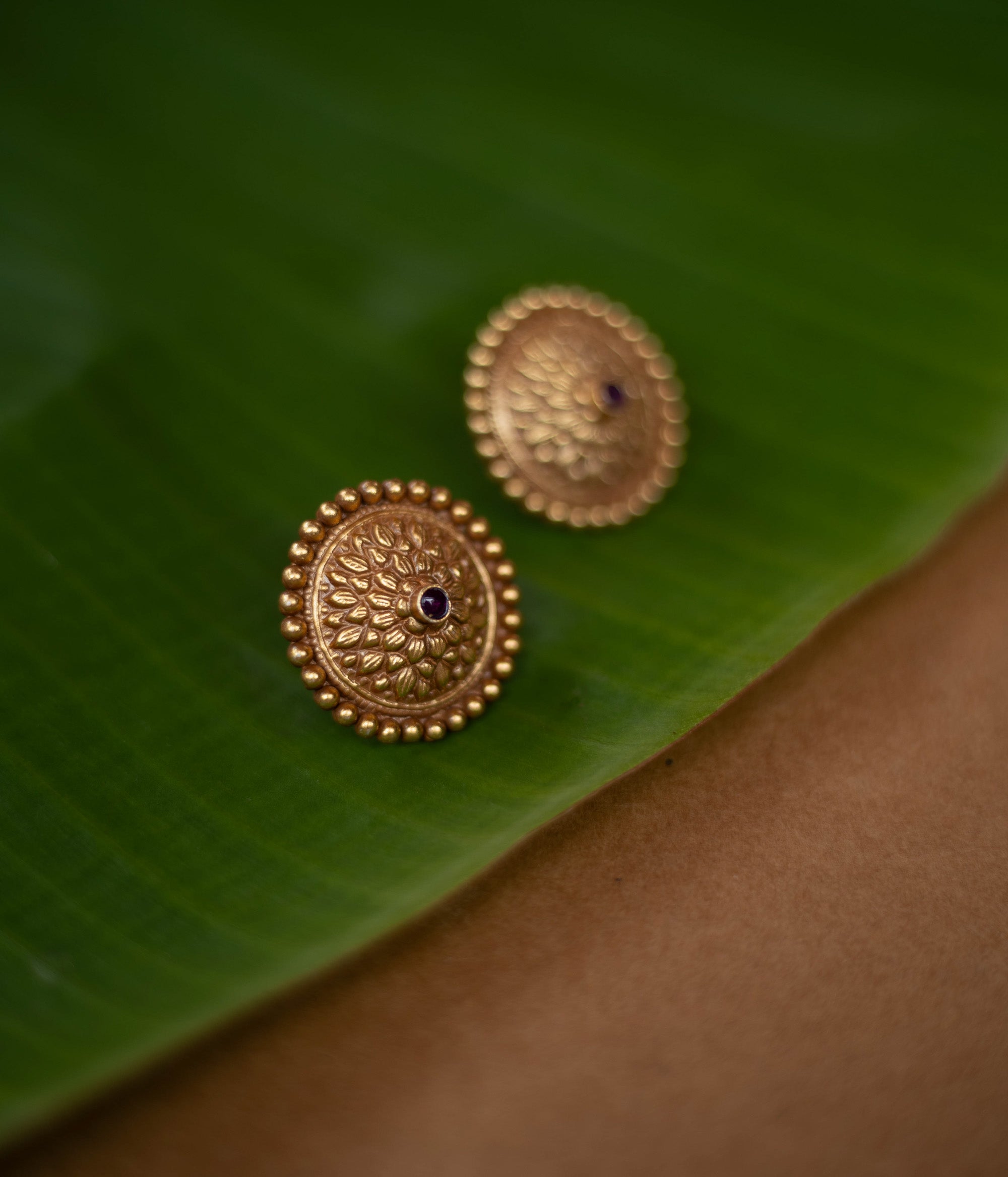 Mithra earrings with red spinel stones, tribal sunburst design in 92.5 sterling silver and 22ct gold plating.