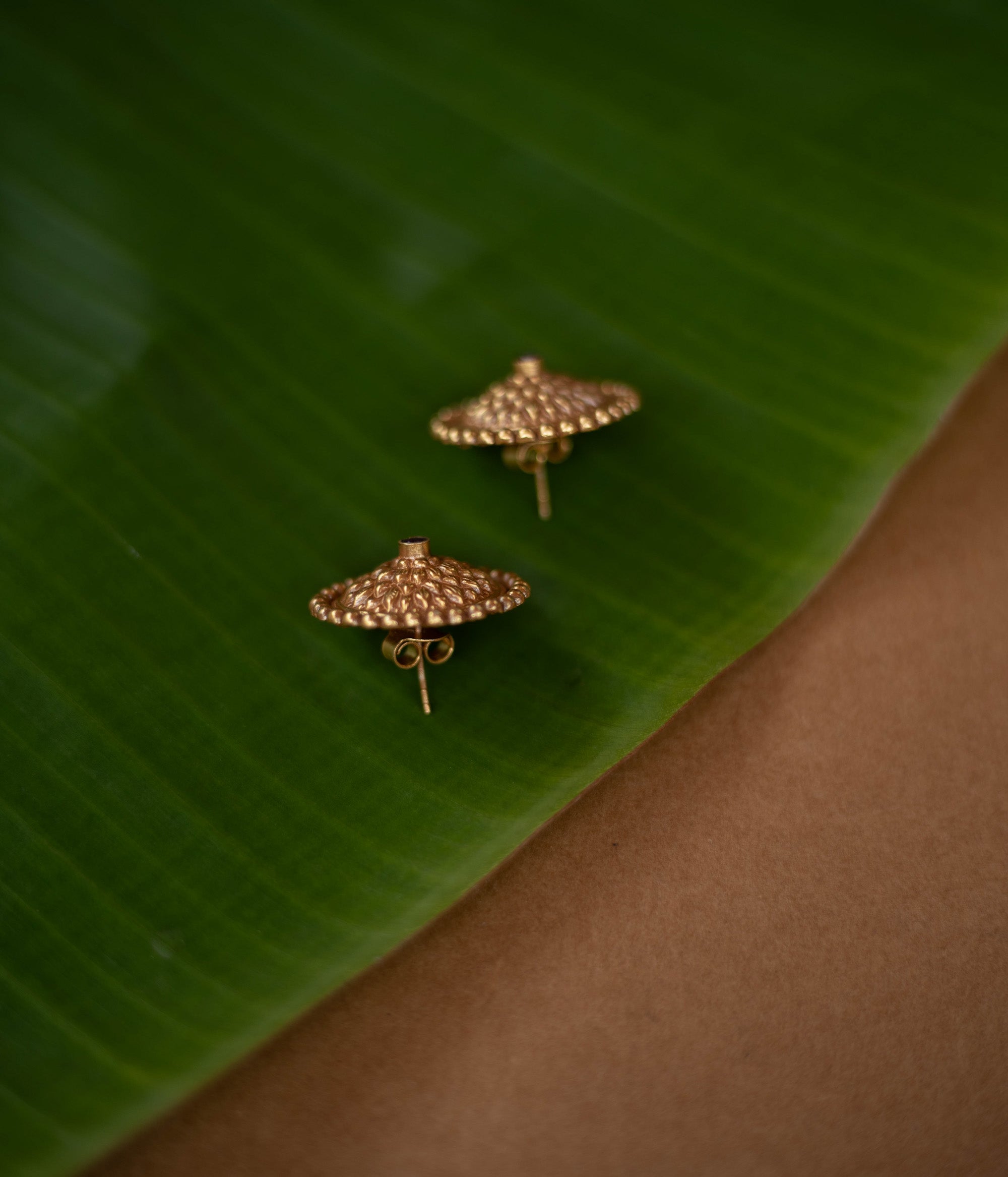 Mithra earrings with red spinel stones, tribal sunburst design in 92.5 sterling silver and 22ct gold plating.