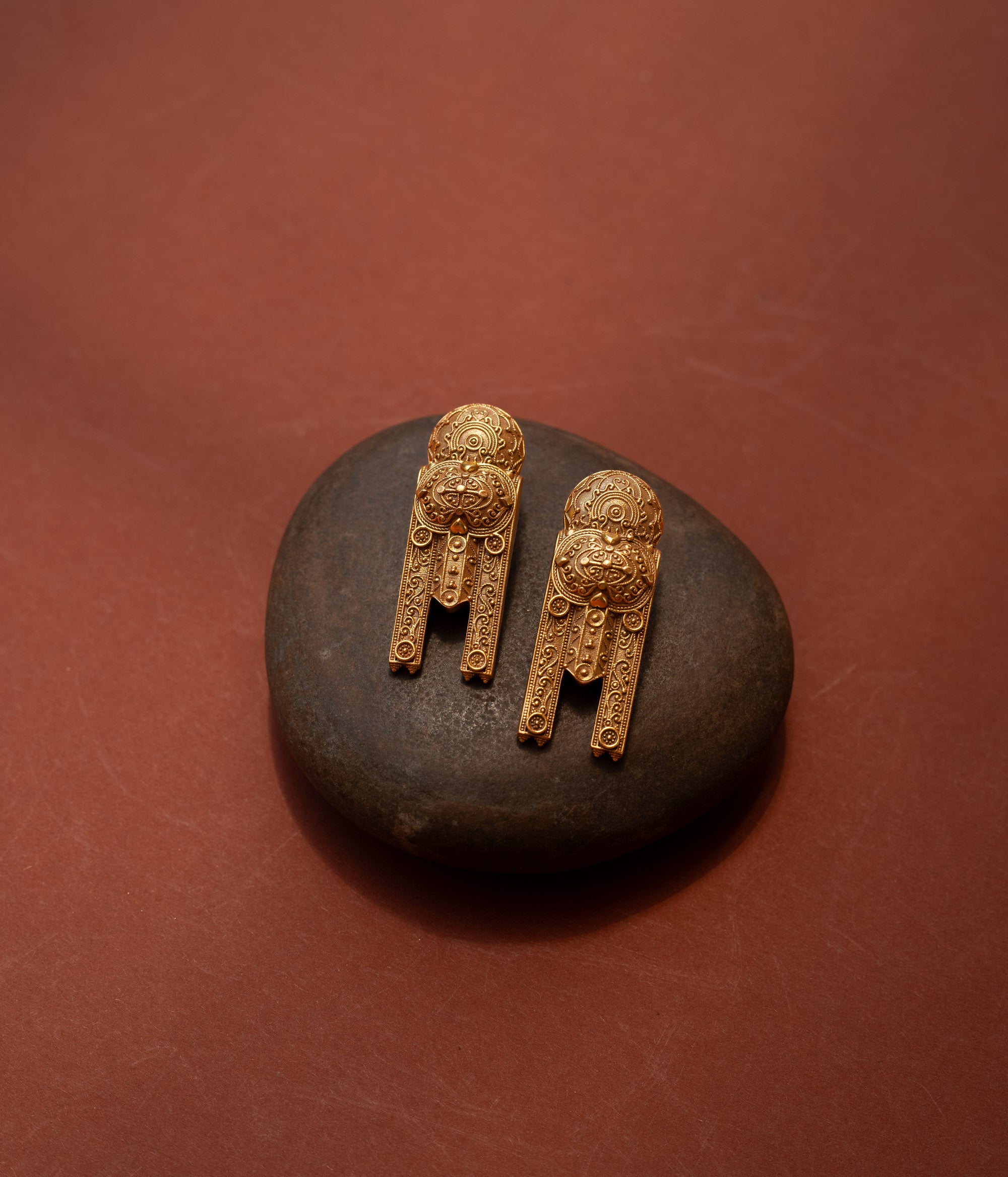 Gold tribal earrings with lion motif and yantra-inspired patterns from the Tribal Collection.