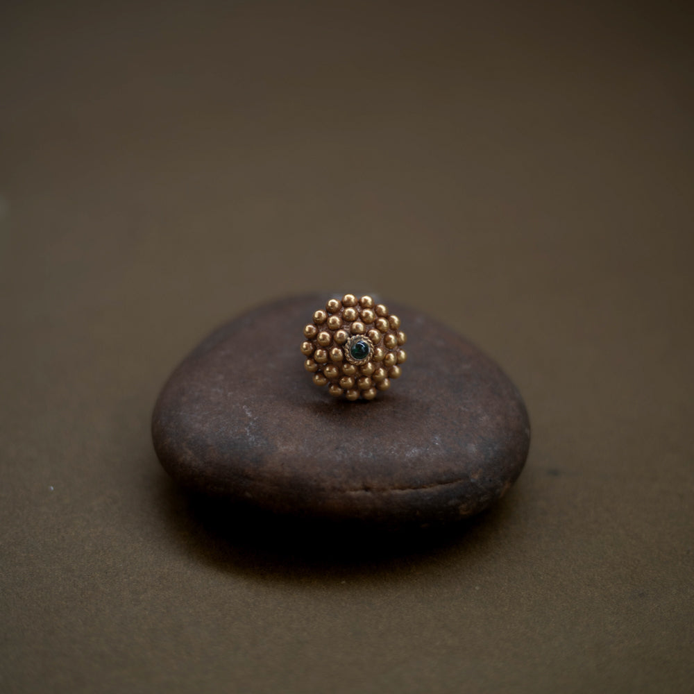 Tribal floral ring handcrafted from 92.5 sterling silver with rich 22ct gold plating, featuring a green spinel stone at the center.