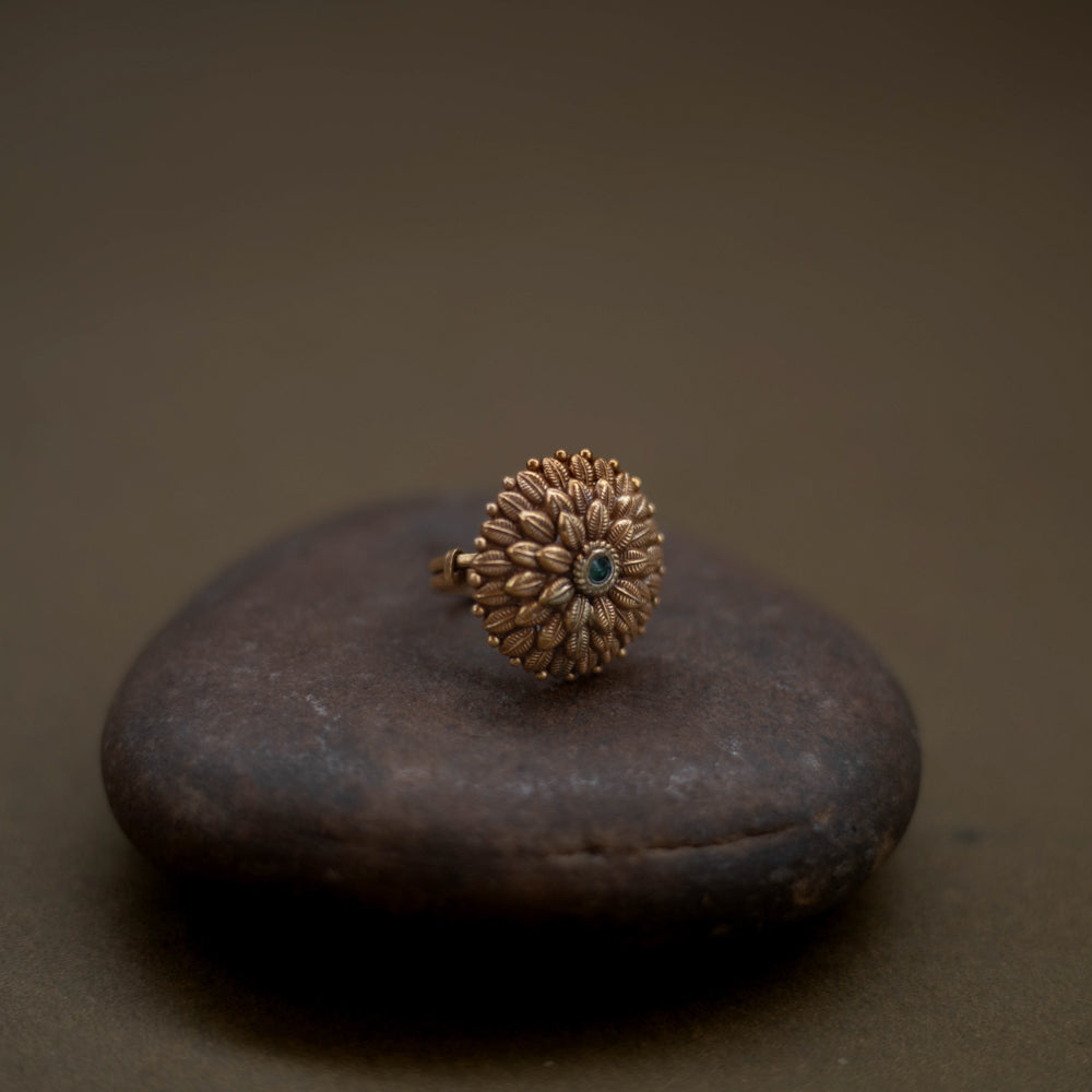Tribal floral ring handcrafted from 92.5 sterling silver with rich 22ct gold plating, featuring a green spinel stone set in a detailed petal design.
