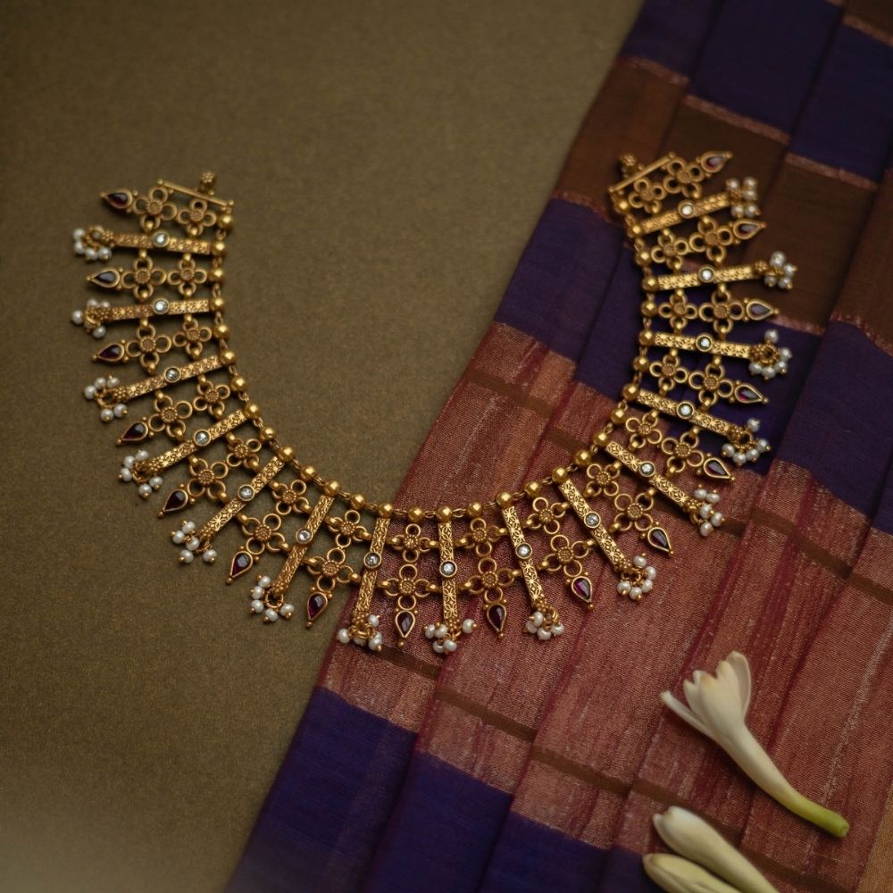 Traditional Katha necklace with red and white spinal stones, pearls, and floral danglers.