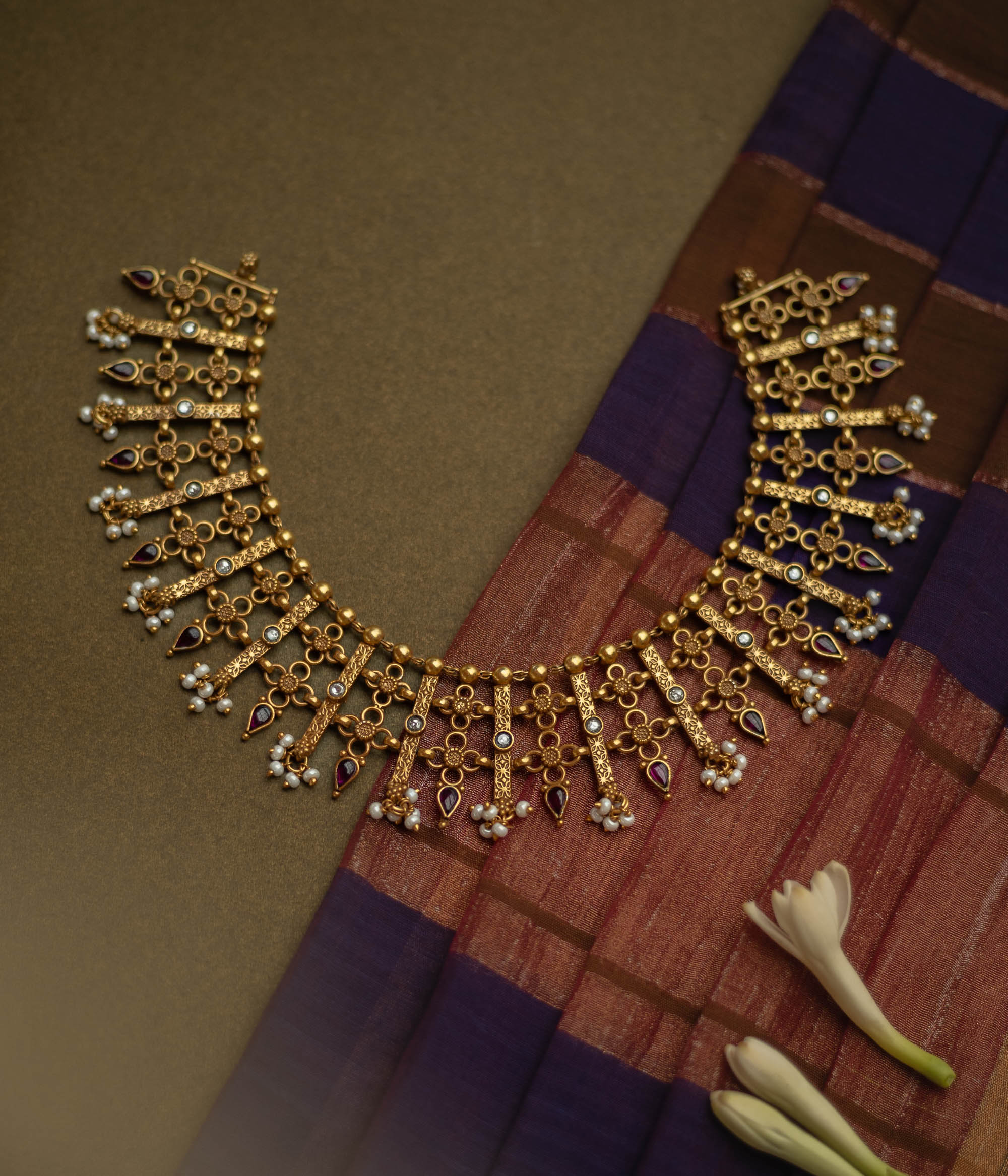 Traditional Katha necklace with red and white spinal stones, pearls, and floral danglers.