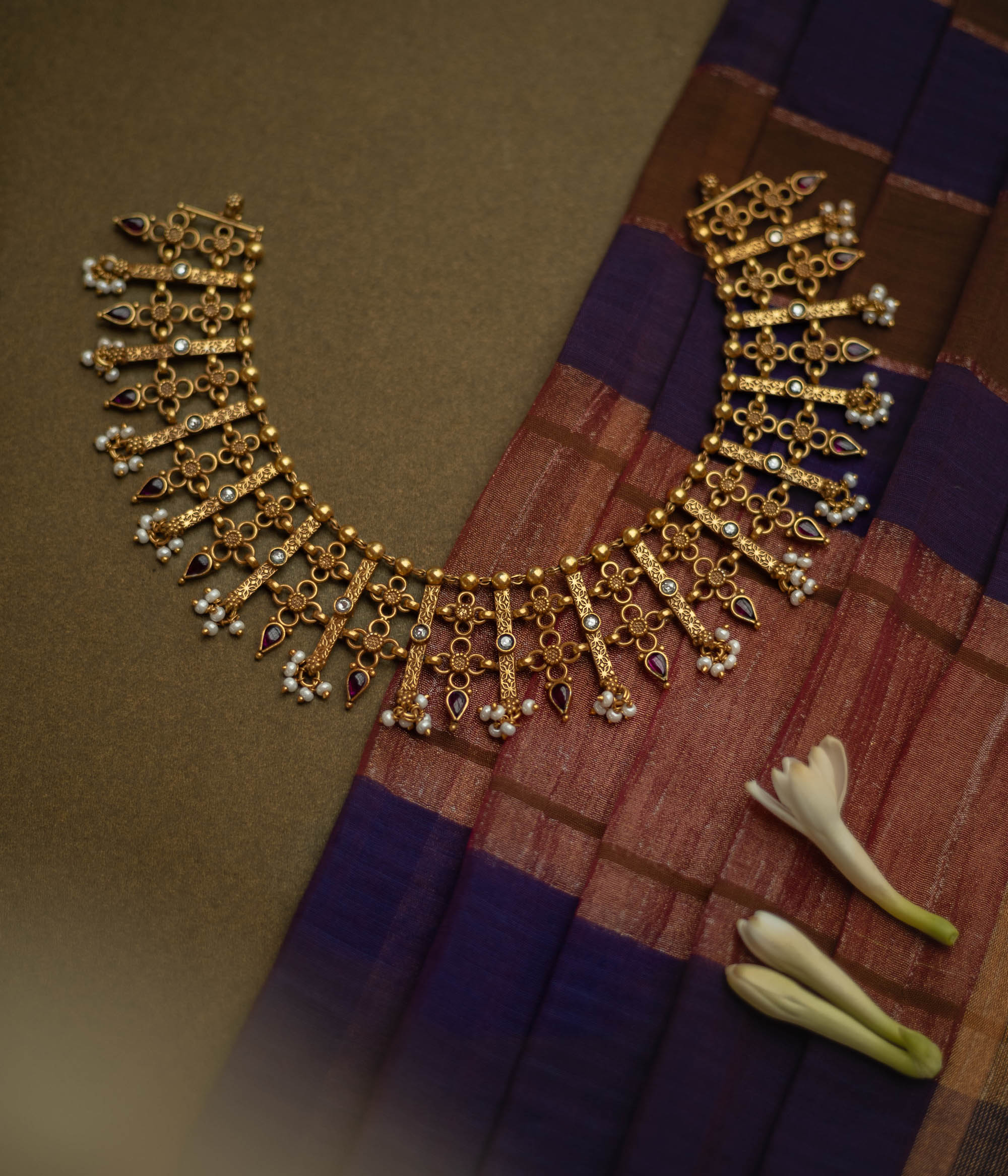 Traditional Katha necklace with red and white spinal stones, pearls, and floral danglers.