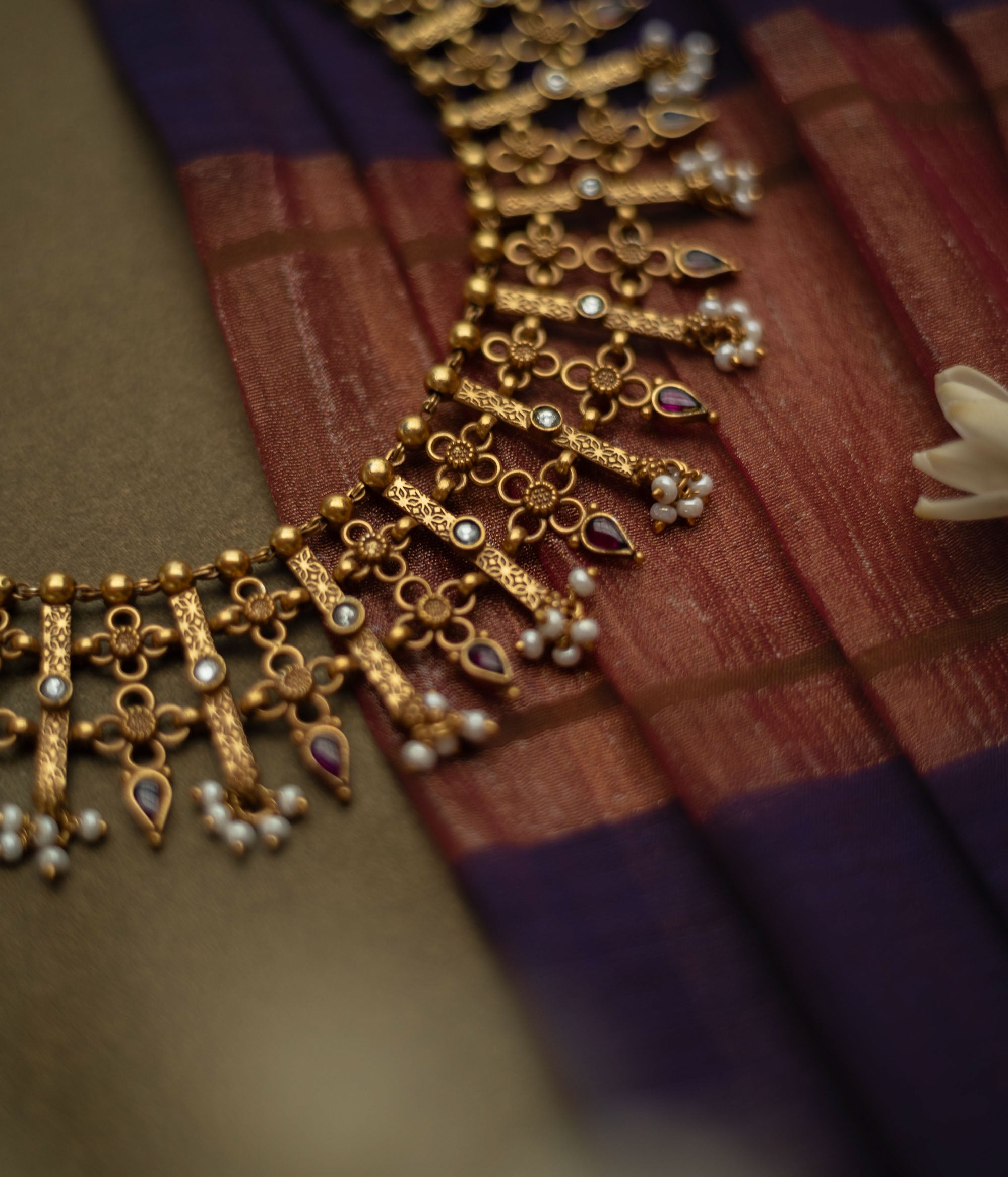 Traditional Katha necklace with red and white spinal stones, pearls, and floral danglers.
