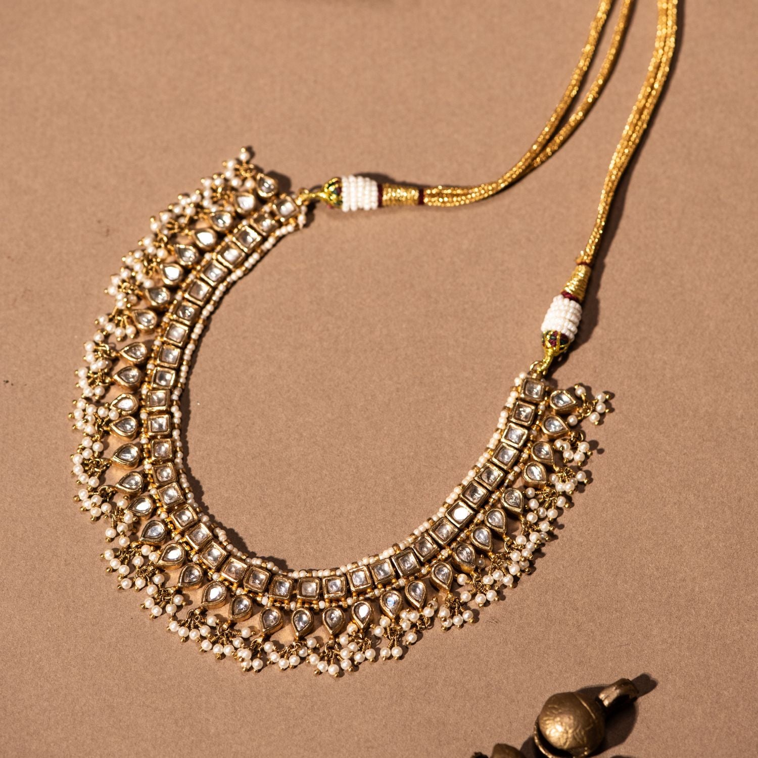 Gold-plated silver necklace adorned with shimmering white sapphires and elegant white pearl drops, designed to exude sophistication and grace, perfect for enhancing any special occasion attire.