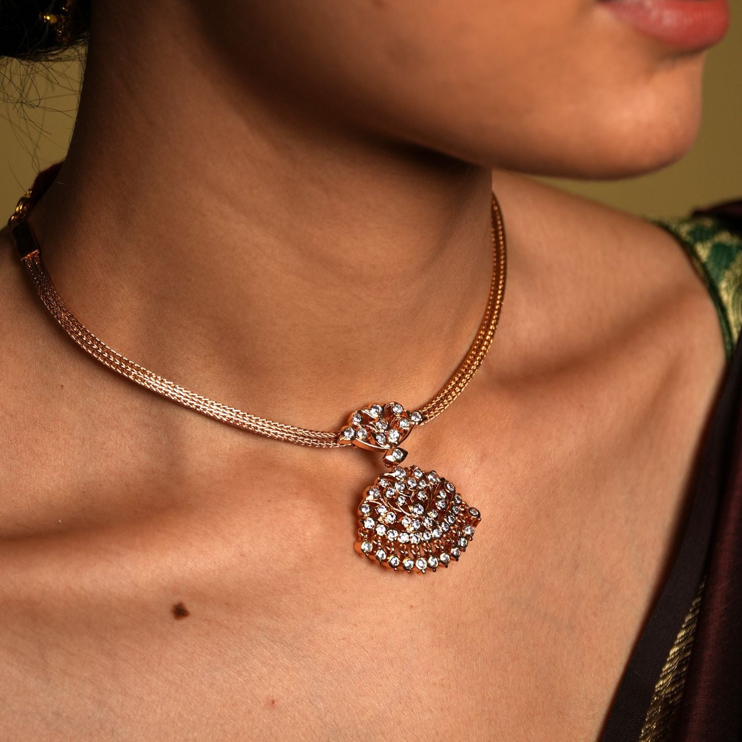 Crafted from high-quality 925 sterling silver and elegantly gold-plated, this choker features a traditional Chettinad pendant that embodies vintage sophistication. The gold plating gives the piece a luxurious glow, while the intricate details of the pendant reflect the rich heritage of Chettinad craftsmanship.