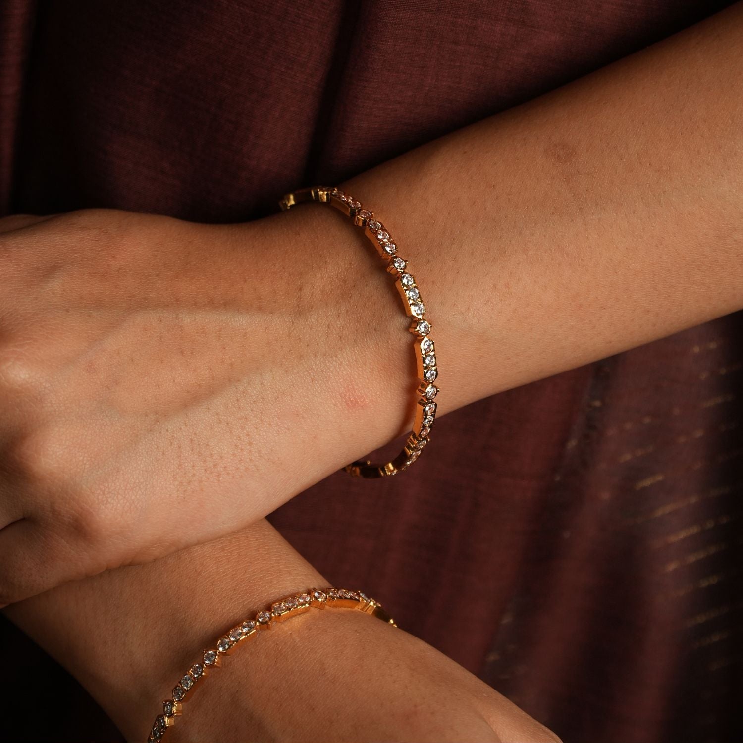 Capture the light with these stunning bangle bracelets, meticulously crafted with dazzling Swarovski crystals.  Each bangle showcases a delicate row of brilliantly faceted crystals, catching and reflecting light with every movement.