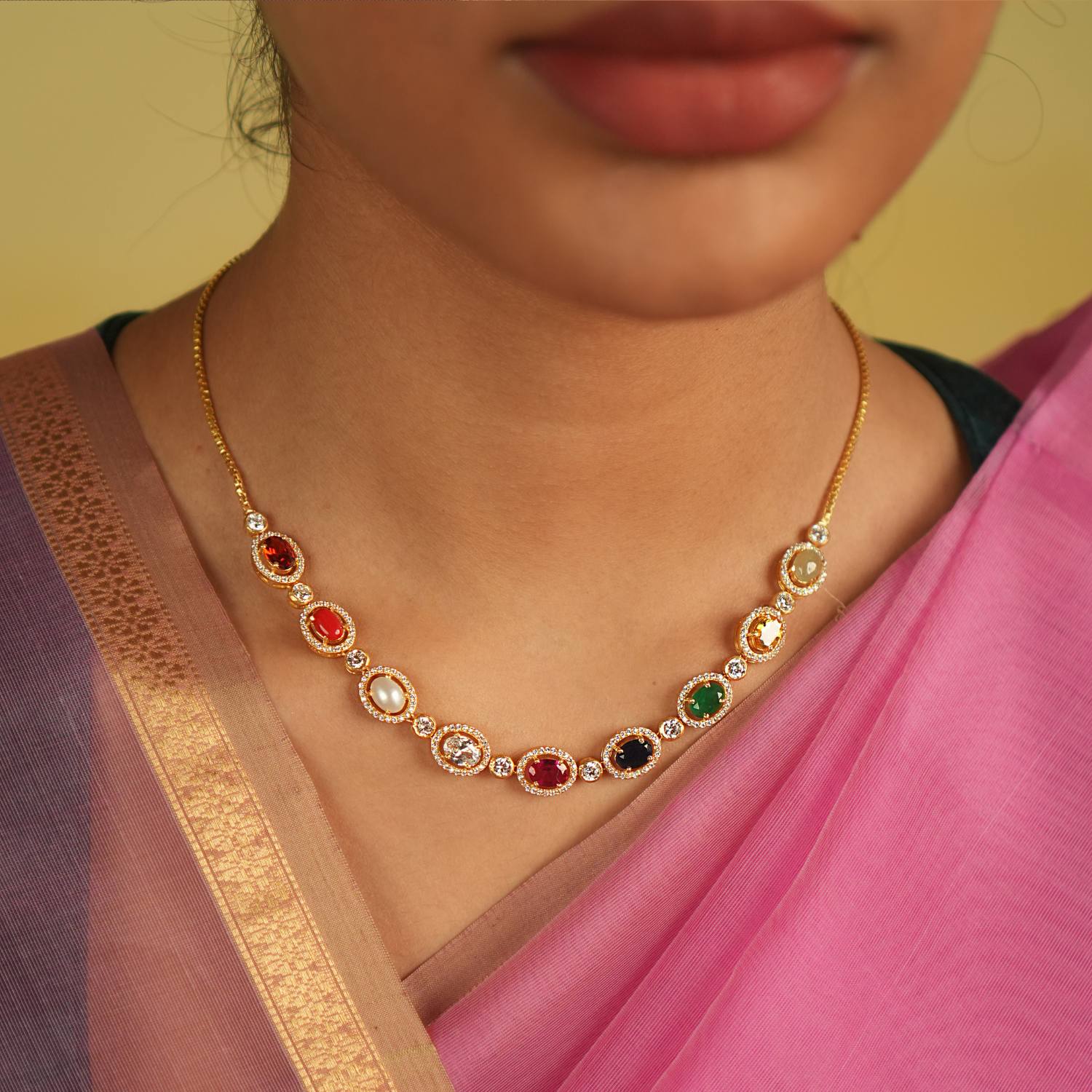 A sleek Navaratna necklace, adorned with shimmering Moissanites, radiates celestial grace and timeless charm.