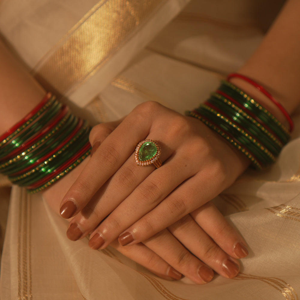 Temple collection Kimaya Ring featuring a teardrop emerald gemstone with a moissanite halo, radiating serene luxury.