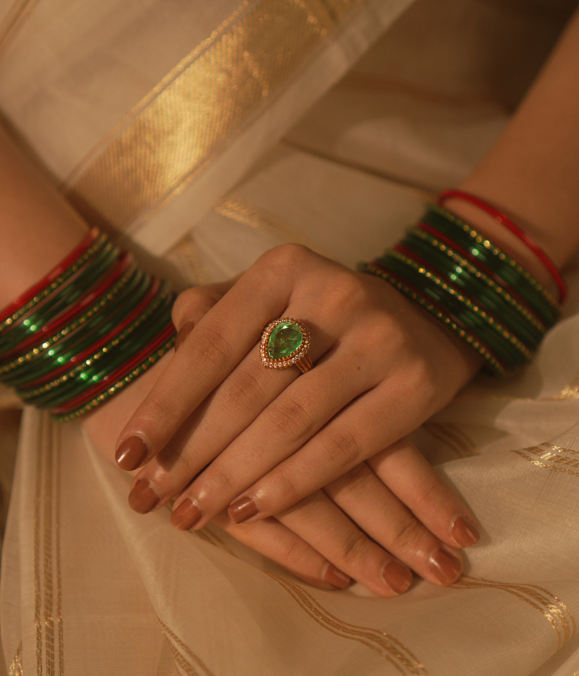 Temple collection Kimaya Ring featuring a teardrop emerald gemstone with a moissanite halo, radiating serene luxury.