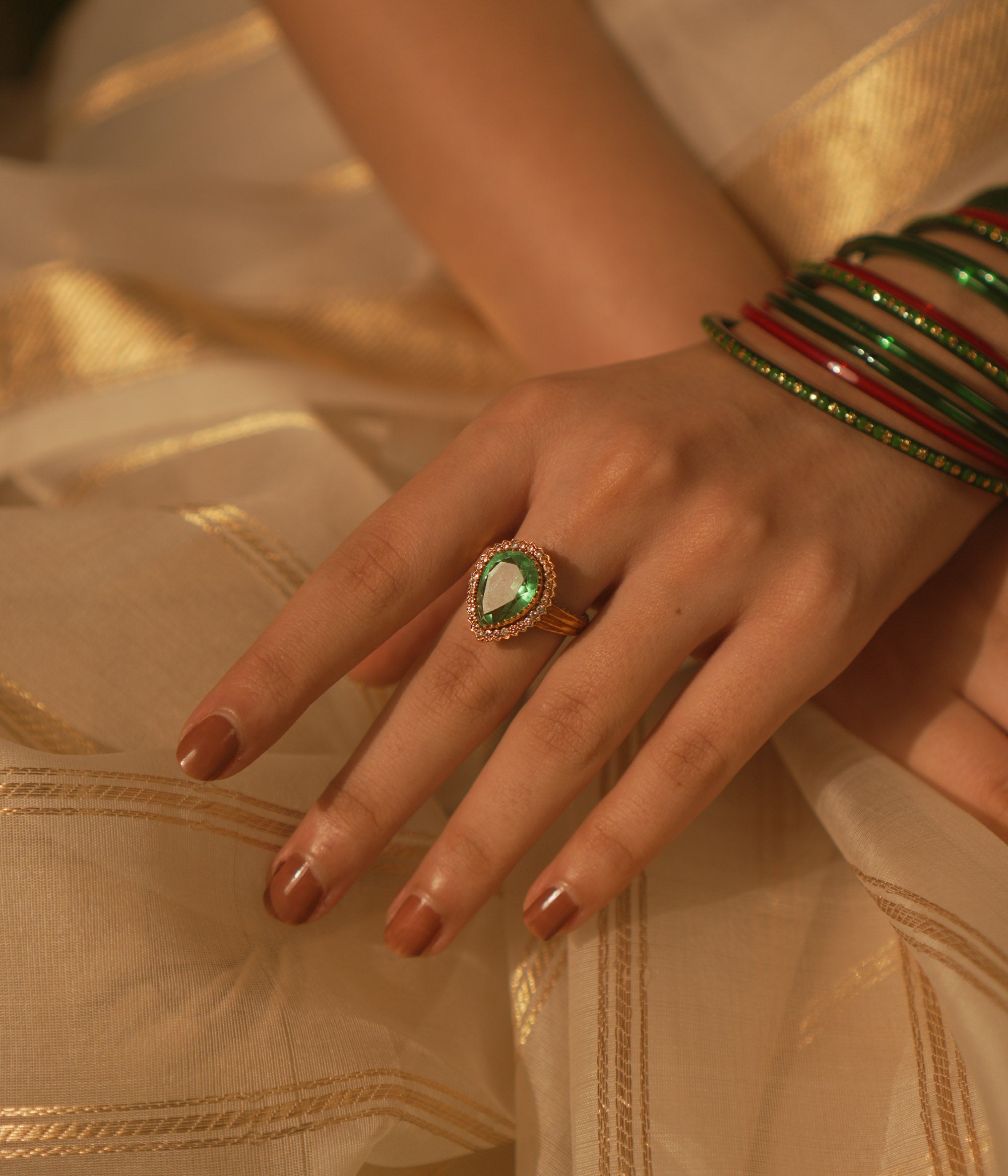 Temple collection Kimaya Ring featuring a teardrop emerald gemstone with a moissanite halo, radiating serene luxury.