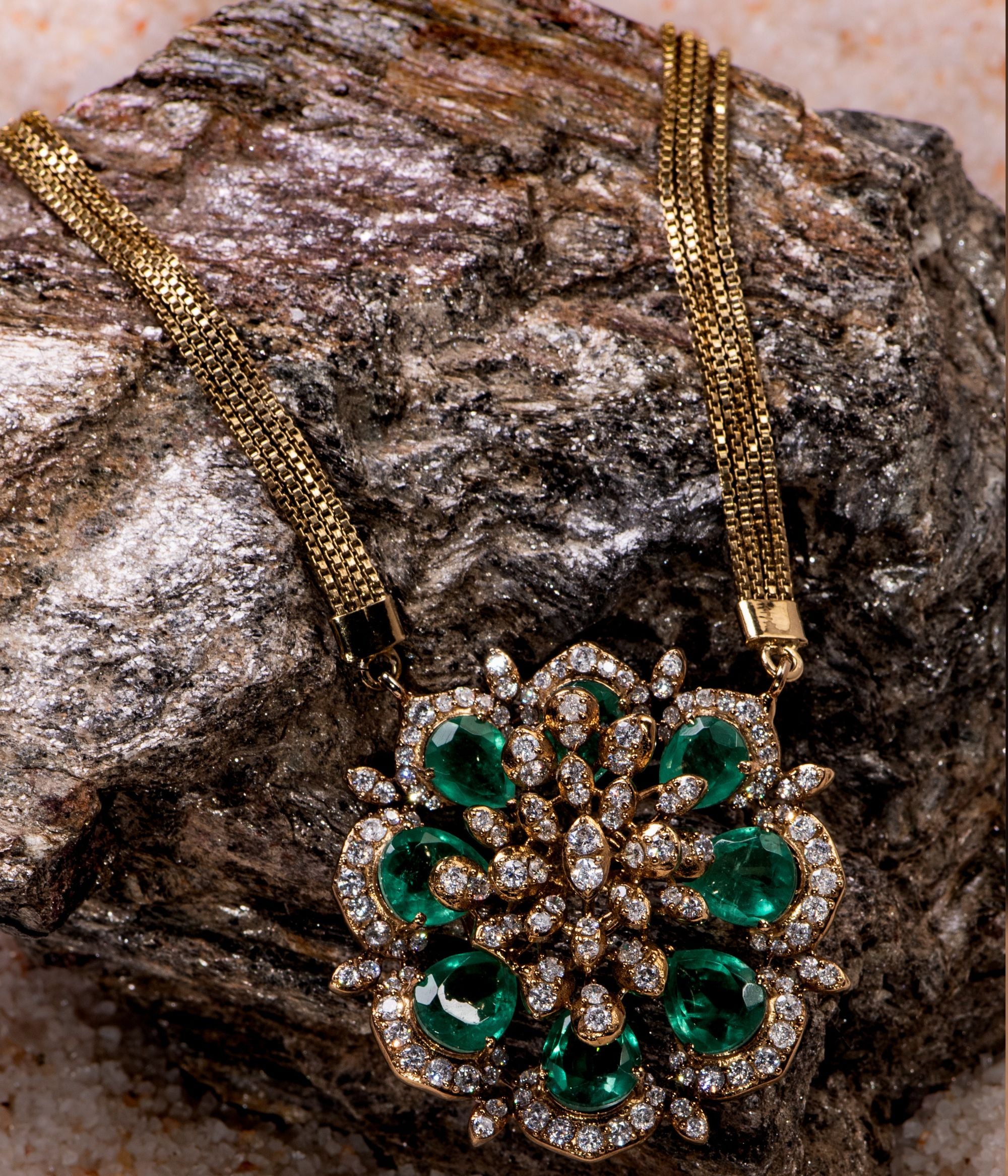 Necklace with a floral-shaped pendant adorned with Moissanite Polki stones and green tourmaline stones, elegantly attached to a delicate gold-plated chain, perfect for adding a touch of sophistication and charm to any outfit.