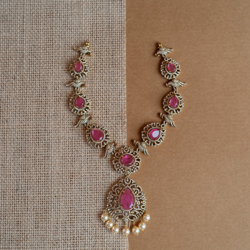 Gold Victorian necklace with pink gemstones, CZ stones, bird motifs, and dangling pearls.