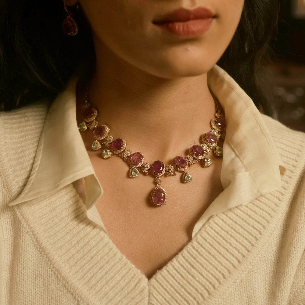 Victorian necklace with red Polki stones, green Polki drops, and CZ floral detailing in gold finish.