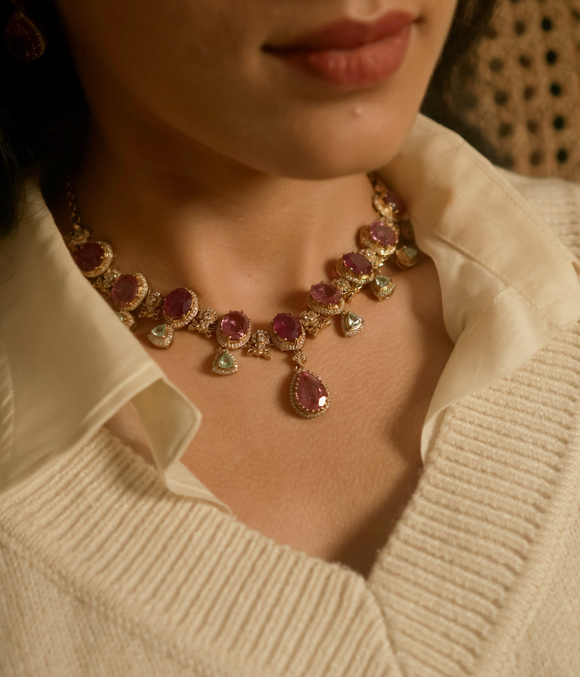 Victorian necklace with red Polki stones, green Polki drops, and CZ floral detailing in gold finish.