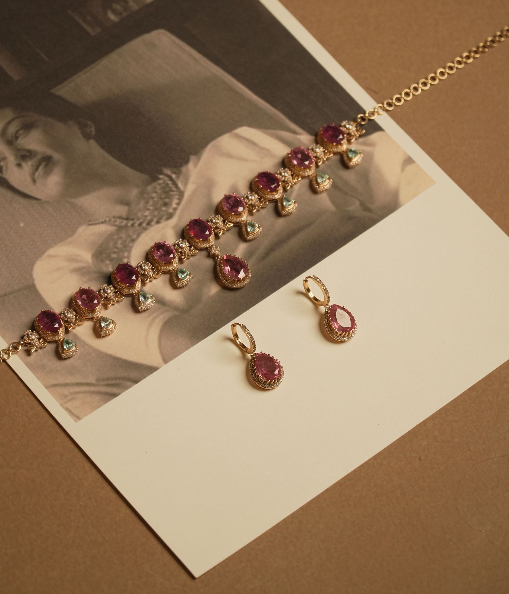 Victorian necklace with red Polki stones, green Polki drops, and CZ floral detailing in gold finish.