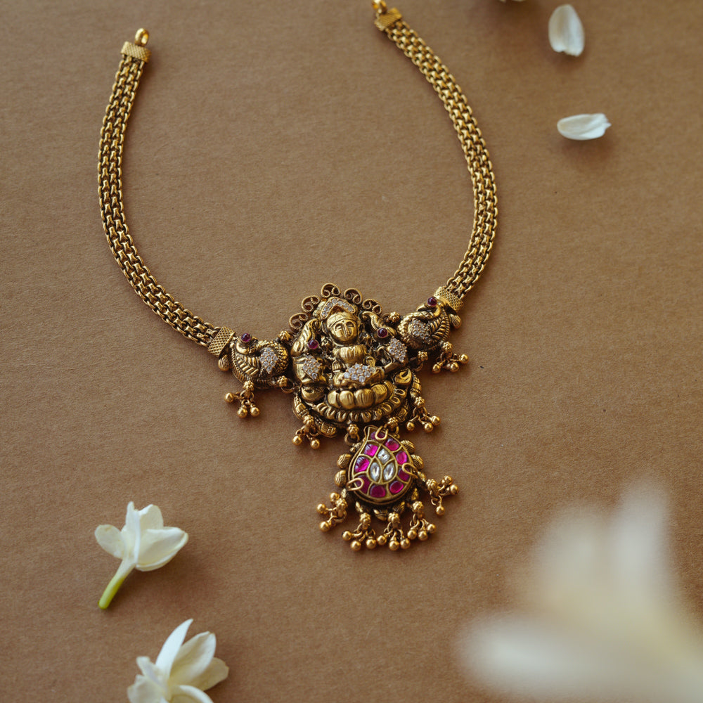 Antique gold Lakshmi temple necklace with peacock motifs, Red Spinel, Kundan, and CZ stones.